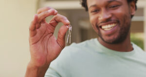 First home buyer in Brisbane holding keys to new property under Boost to Buy program